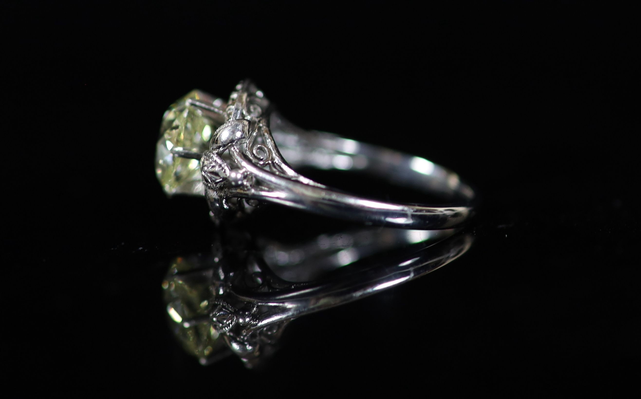 A white gold and oval cut solitaire diamond ring, in a raised claw setting